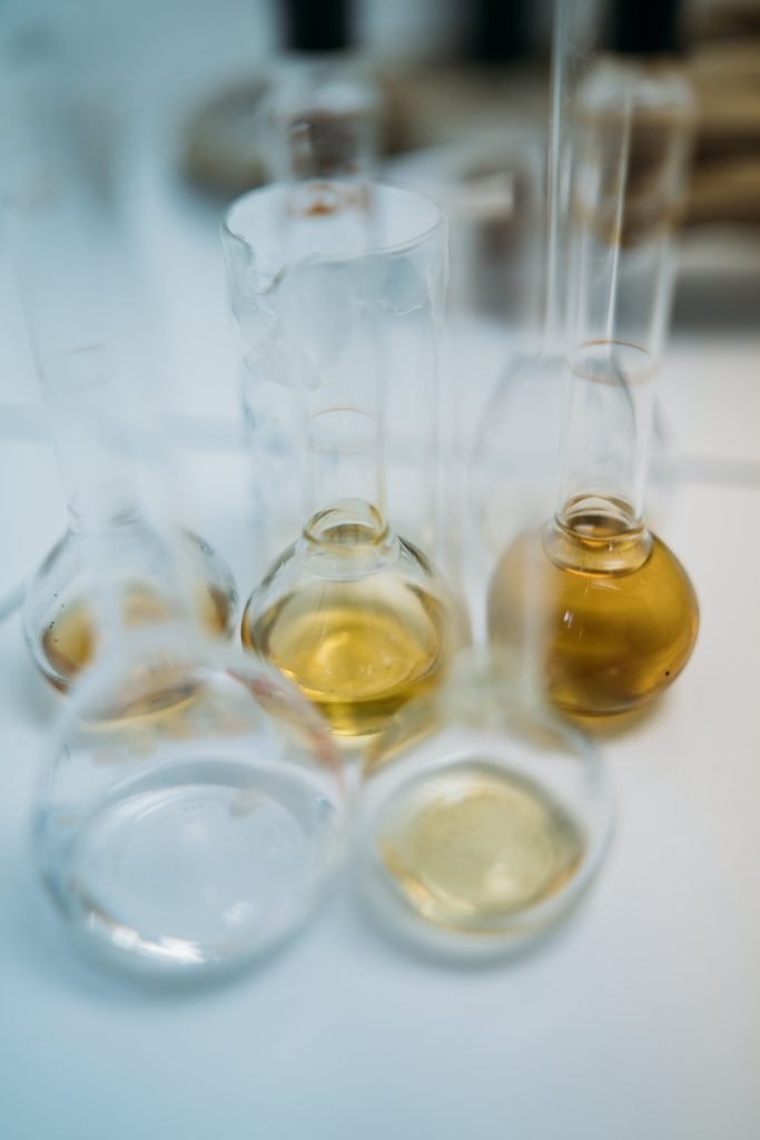 Clear Glass Bottles on White Table
